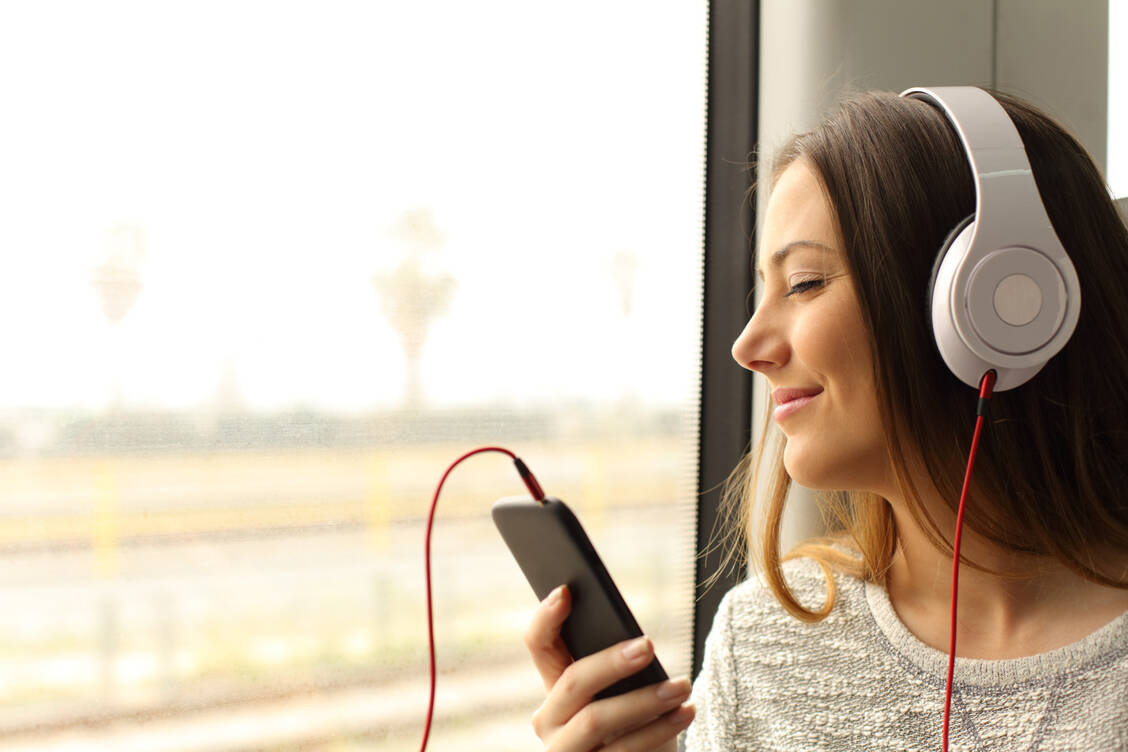 Ob fröhlich oder sanft – die richtige Musik kann Reiseübelkeit lindern. / © Adobe Stock/Antonioguillem