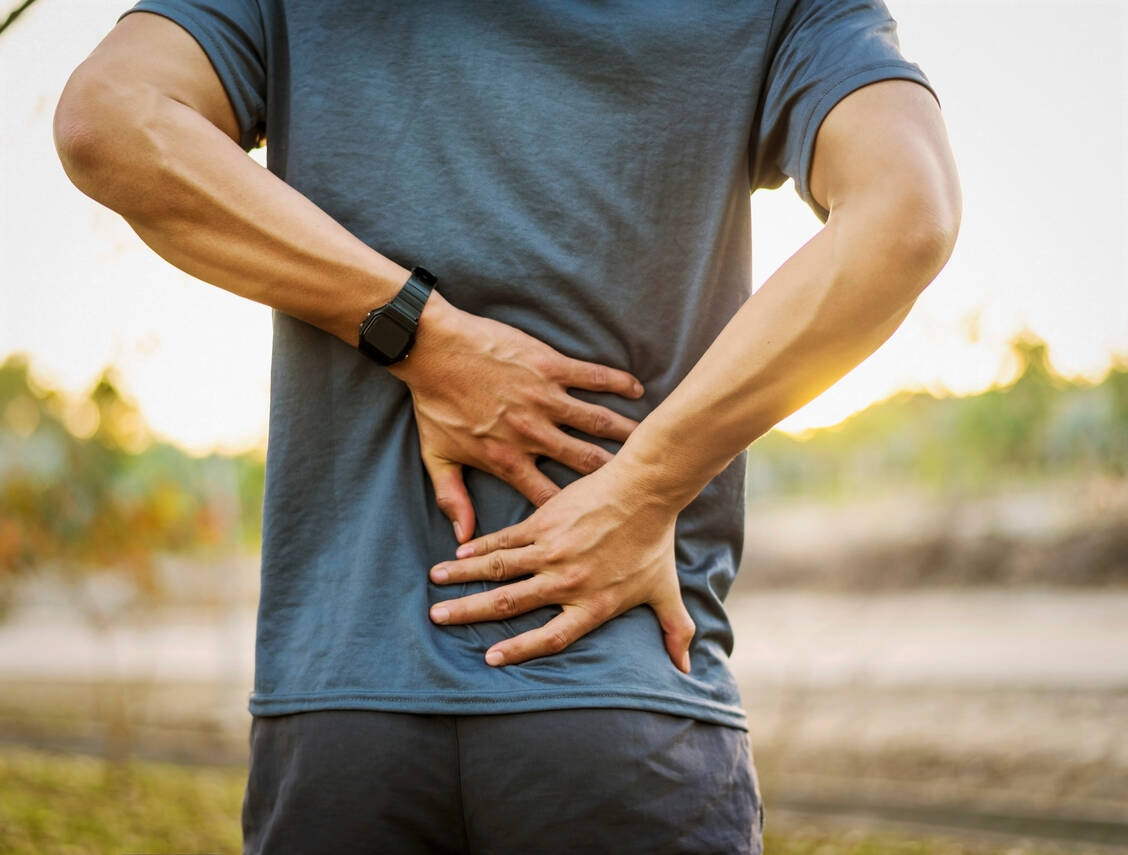 Bei Schmerzen im unteren Rückenbereich können Zubereitungen der Arzneidrogen Cayennepfeffer und  Weidenrinde angewendet werden. Beide haben vom HMPC den Well-established-Use-Status erhalten. / Foto: Shutterstock/TB studio