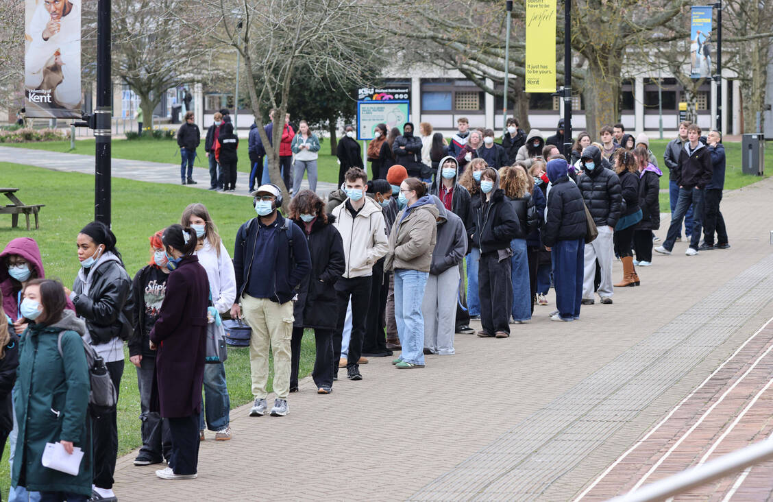 Studierende stehen am heutigen 17. März vor einem Gebäude der Universität Kent in Canterbury Schlange, um Antibiotika zu erhalten. / © Imago/News Licensing